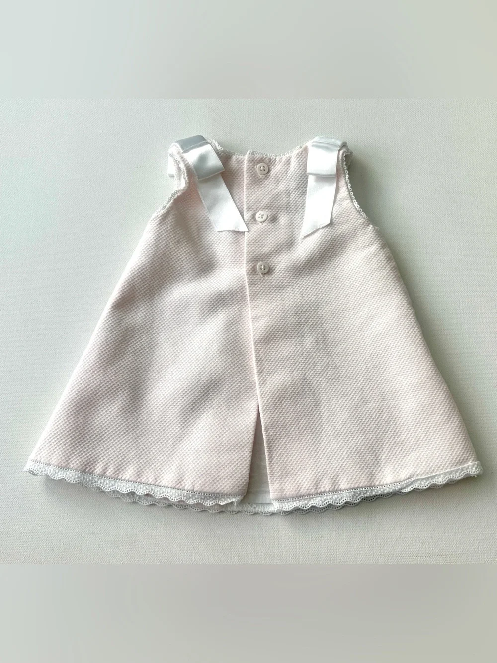Dulces girl’s pique dress is classic Spanish-style heirloom garment.  Size 0-3M.